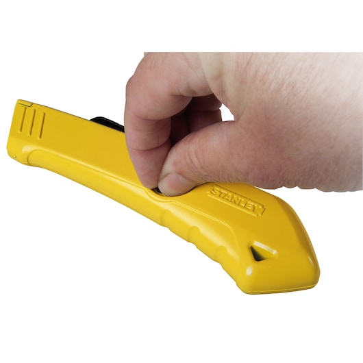 STANLEY STHT0-10193 yellow utility knife in hand, side angle, showing ergonomic design and brand logo.