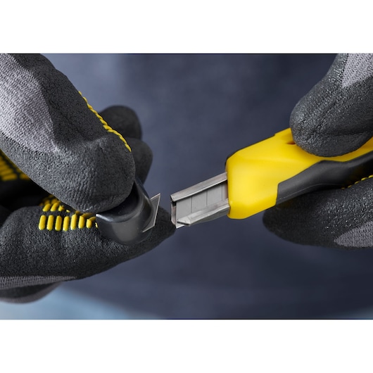 STANLEY STHT0-10264 utility knife, close-up of yellow and black handle with gloved hands changing blade.