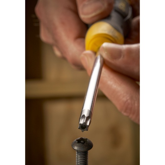 STANLEY STHT0-65153 screwdriver with silver Torx bit driver close to a Torx screw, demonstration view.