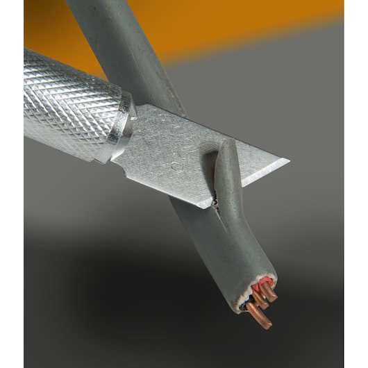 STANLEY STHT0-73872 utility knife cutting gray electrical cable, close-up angle, product photography.