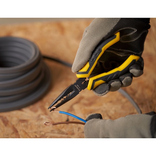 STANLEY STHT0-74364 long nose pliers cutting copper wire, yellow and black handle, close-up action.