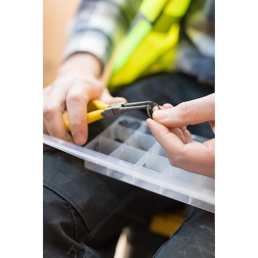 STANLEY STHT0-75412 photography of yellow-handled pliers holding a small ring above a plastic organizer box.