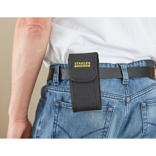 STANLEY STHT1-77140 black tool pouch attached to a belt on denim jeans, close-up side view.