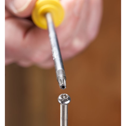 STANLEY STHT16179-0 precision screwdriver tip aligned with a torx screw, close-up photography.