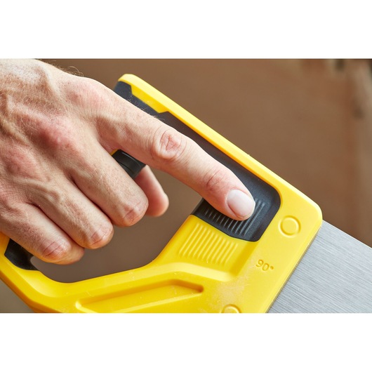 STANLEY STHT20351-1 hand saw, close-up of yellow handle and adjustment grip held by a finger.
