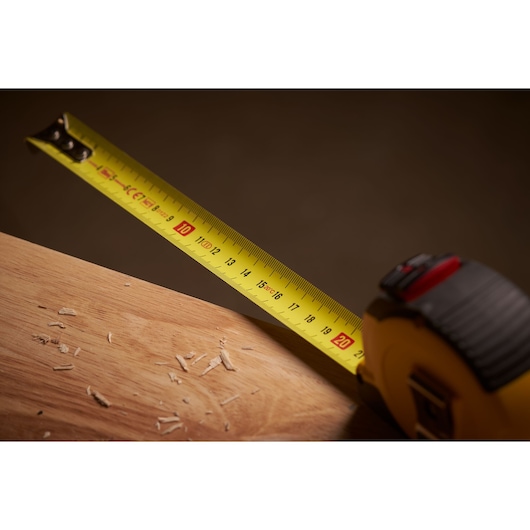 STANLEY STHT36804-0 tape measure extended on wood surface, close-up photography.