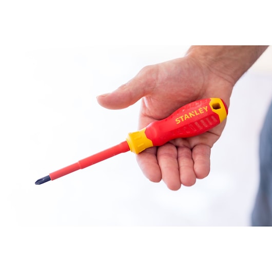 Photo of STANLEY STHT60031-0 insulated red and yellow screwdriver held in a hand.