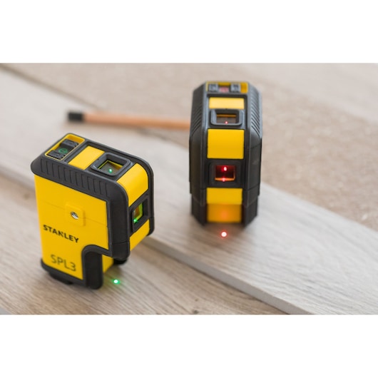 Photo of STANLEY STHT77503-1 yellow SPL3 laser levels on wood surface, close-up, product category Photography.
