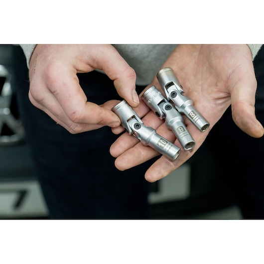 STANLEY STHT81015-0 silver swivel socket set held in hand, photography close-up.