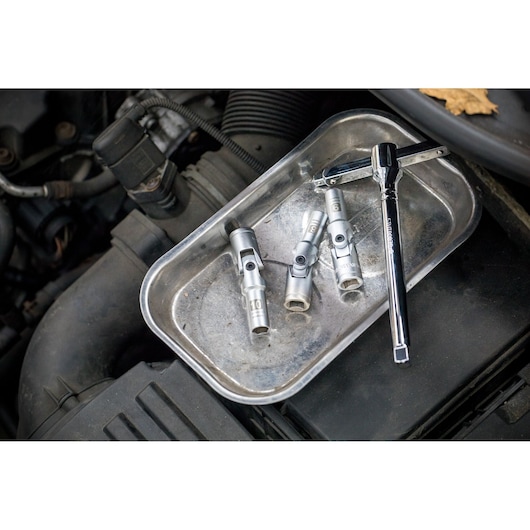 STANLEY STHT81016-0 socket wrench set with four socket attachments on metal tray, automotive context.