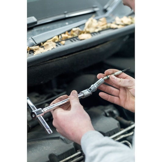 STANLEY STHT81016-0 socket wrench in use for automotive repair, close-up of tool and hands.