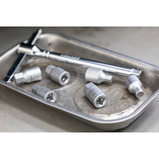 STANLEY STHT81574-0 socket wrench and hex sockets set in a metal tray, angled view.