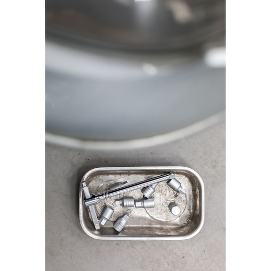 STANLEY STHT81578-0 mechanic tools with sockets and ratchet in metal tray, top view.