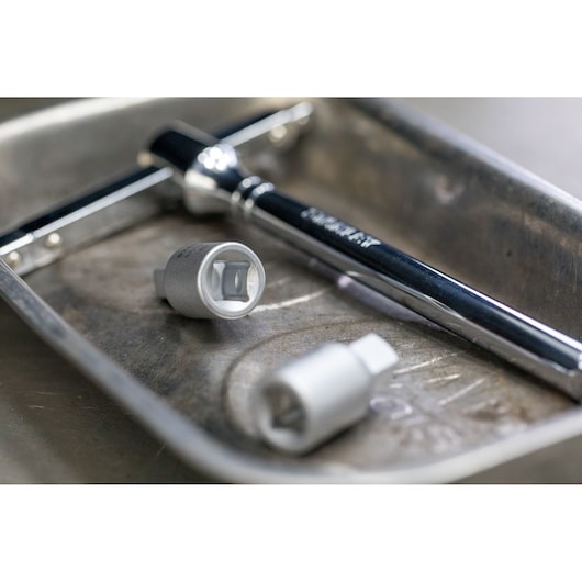 STANLEY STHT81580-0 socket wrench and sockets in a metal tray, close-up photography.