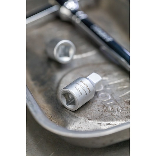 STANLEY STHT81581-0 10mm socket in metal tray with ratchet wrench, close-up view.