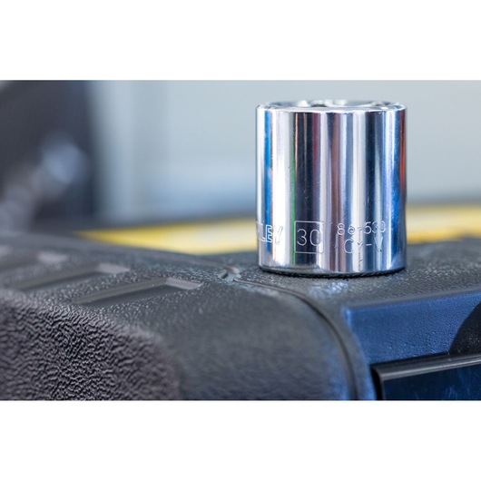 STANLEY STMT82828-1 chrome socket tool, close-up, placed on textured black surface.