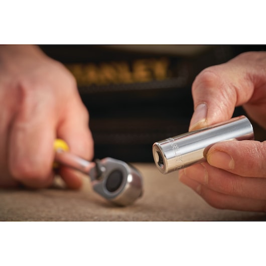STANLEY STMT86095-0 socket held in hand near ratchet, close-up, photography of hand tools.