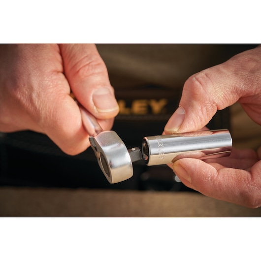 Photo of STANLEY STMT86116-0 socket and ratchet tool held by hands, chrome finish, close-up.