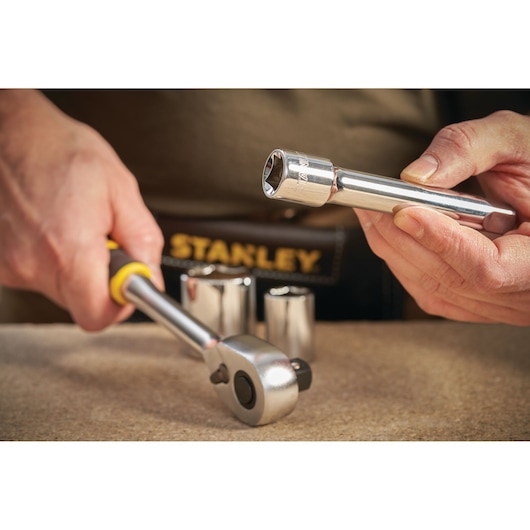 Stanley STMT86407-0 socket wrench set on table, close-up, with chrome sockets and ratchet tool.