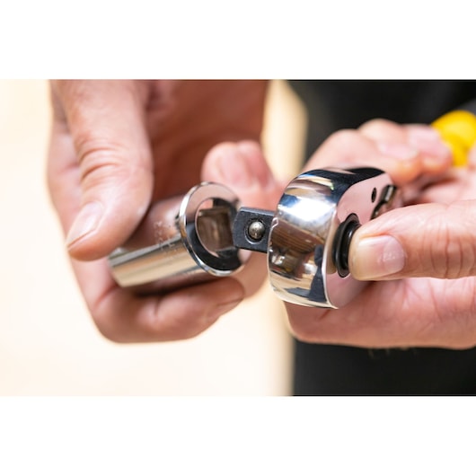 STANLEY STMT86522-0 ratchet wrench with socket, close-up photo in hand.