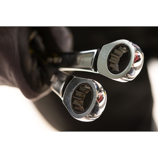 STANLEY STMT89919-0 ratcheting wrenches close-up held in a gloved hand, metallic finish.
