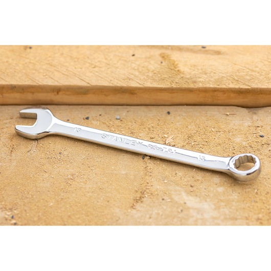 STANLEY STMT95787-0 combination wrench, chrome finish, photographed on a workbench, Photography category.