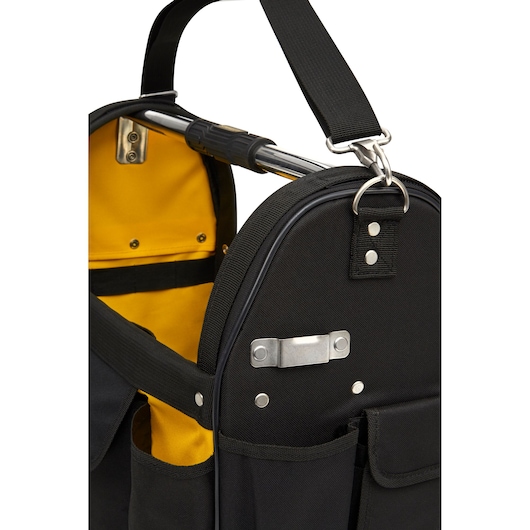 STANLEY STST1-70712 tool bag in black fabric with yellow interior, metal handle, shoulder strap, and outer pockets, side view.