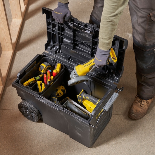 STANLEY STST1-70715 mobile tool chest top view with assorted yellow and red tools inside.