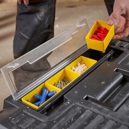 STANLEY STST1-70715 organizer with yellow removable bins holding assorted screws and wall plugs, top view.