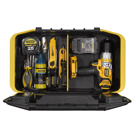 Stanley yellow tool box open with assorted hand tools, tape measure, drill, pliers, and accessories neatly arranged.