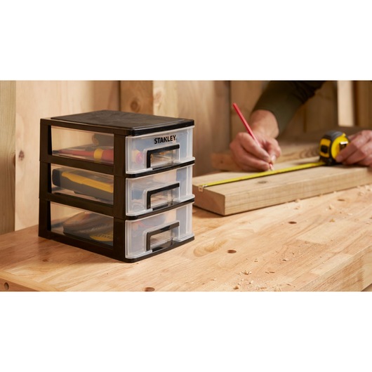 STANLEY STST40710-1 drawer organizer for tools on workbench, side view, workshop setting.