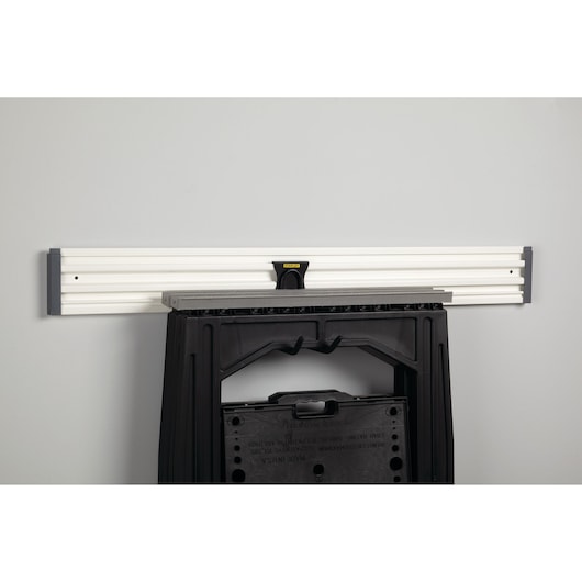 STANLEY STST82608-1 wall-mounted rail with black folding sawhorse hung, front angle, workshop storage accessory.