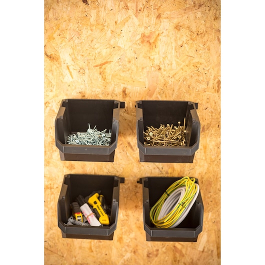 STANLEY STST82734-1 wall-mounted black storage bins holding fasteners, hand tools, and cables, front angle.