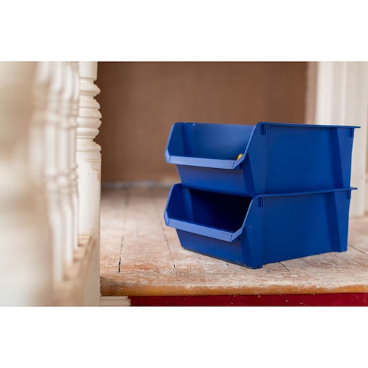 STANLEY STST82746-1 blue stackable storage bins, photo of two bins on wooden floor, side angle.