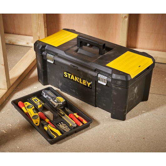 STANLEY STST82976-1 black and yellow toolbox with tray of hand tools on workshop floor.