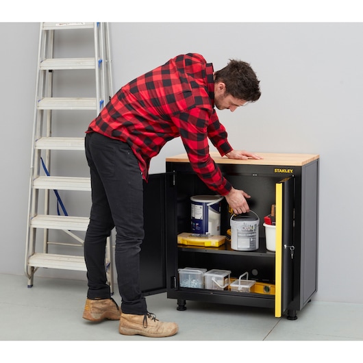 STANLEY STST97595-1 storage cabinet with open doors, showing shelves with tools and supplies in workshop.