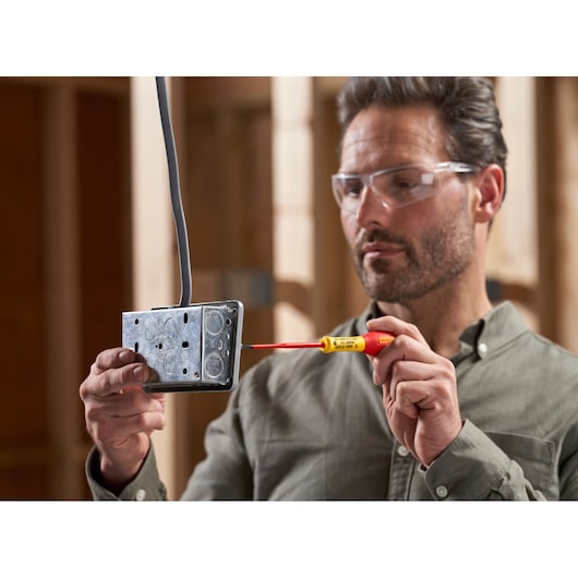 STANLEY XTHT0-62692 screwdriver used on metal electrical box, close-up, photography category.